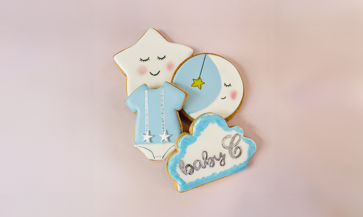 three custom designed cookies. one is a name badge for Max Jr's first birthday, another design of a baby's onesie and the last of a baby deer's face